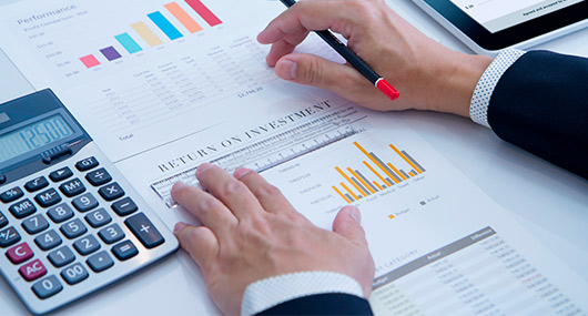 A man in a suit calculates savings on paper, emphasizing high-yield accounts in the RGV.