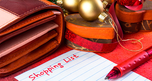 A red pen placed on paper, representing the theme of holiday budgeting tips for South Texas families.